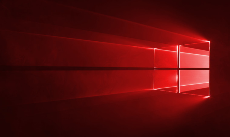 Red-glow Windows logo with illuminated four-pane window on the right, in a dark red background, conveying Windows branding in a dramatic light.